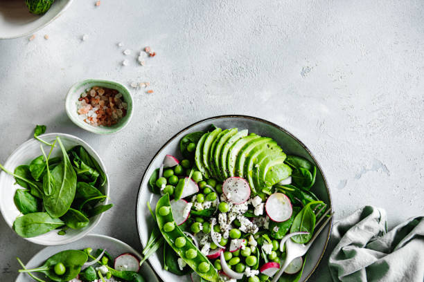 istock Healthy green salad plate with ingredients on the kitchen table 1644564118