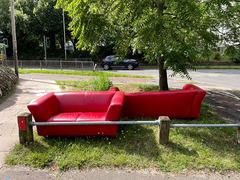 Abandoned red furniture on an urban road