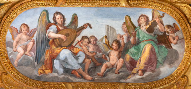 Genova - The fresco of angels choir with the music instrumenst in the church Chiesa del Gesu by Giovanni Carlone from 17. cent.