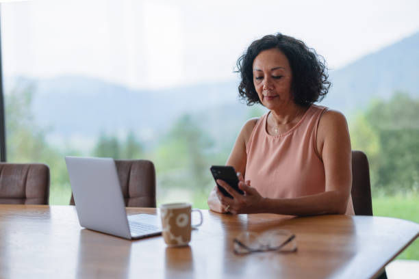 istock Mature Woman Using Her Laptop At Home 1644571353