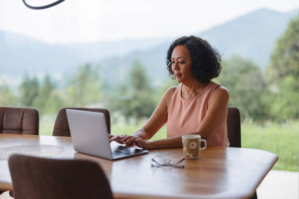 istock Mature Woman Using Her Laptop At Home 1644571376