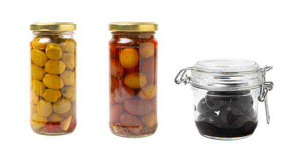 Delicious black, green and red olives in a jar isolated on a white background. Pickled olives in a glass jar. Delicious olives. Close-up. Vegan.Collage. Design.