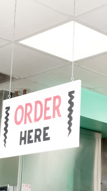 Vertical Shot of Order Here Sign inside Mexican Restaurant