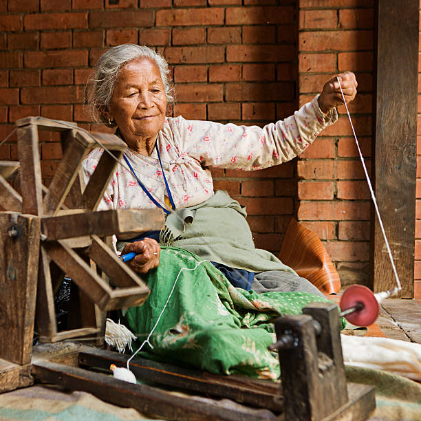 istock Nepali woman spinning the wool. Bhaktapur 164459601