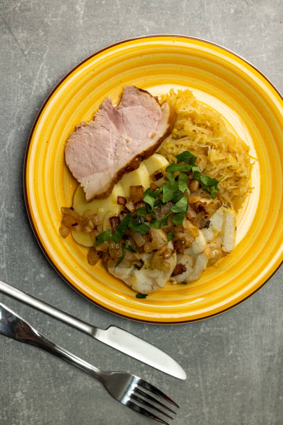 istock pork meat with potato dumplings and pickled cabbage served with roasted onion 1644597442