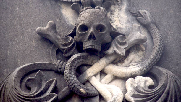 istock sculpture of skull with snake on a tomb 1644598566