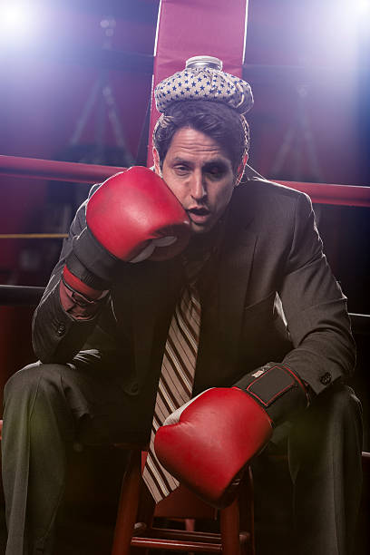 istock Businessman beat against the ropes with ice pack on head 164461243