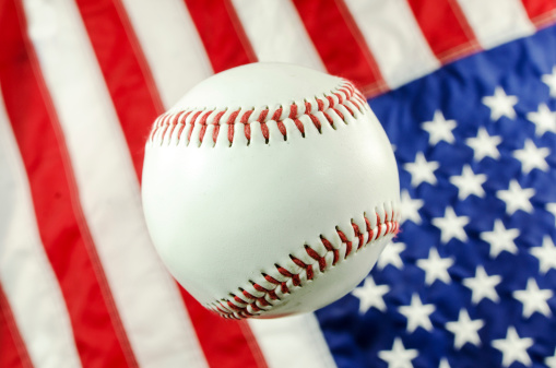 A new baseball with an American flag background.