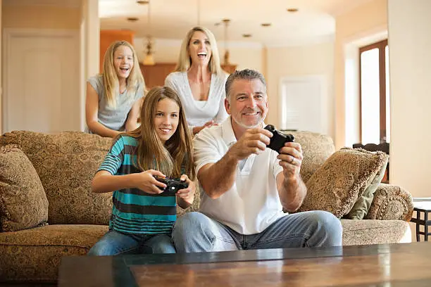 Happy Caucasian family having fun playing videogames at homehttp://i449.photobucket.com/albums/qq220/iphotoinc/KidsBanner.jpg