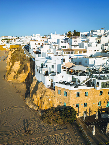 aerial view on Albufeira old town on the cliffs over the beach at sunrise hour