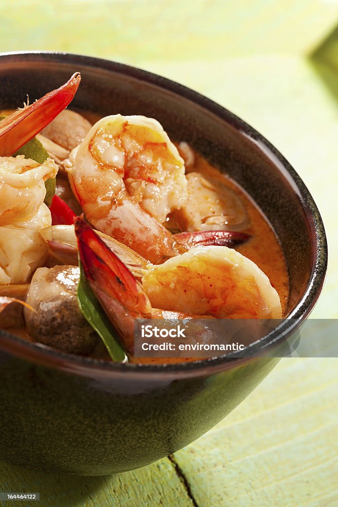 Spicy Thai Tom Yam prawn soup. Spicy Thai Prawn soup (Tom Yam Kung). This famous Thai dish is very spicy and made with lemon grass, kaffir lime leaves, galangal and chili. Prawn - Seafood Stock Photo