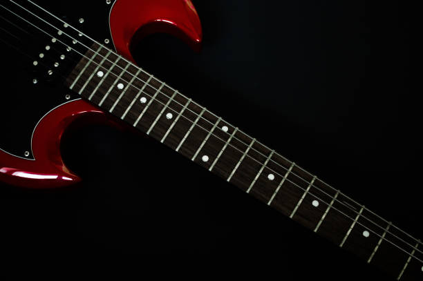 istock Red electric guitar closeup  on black background 1644650097