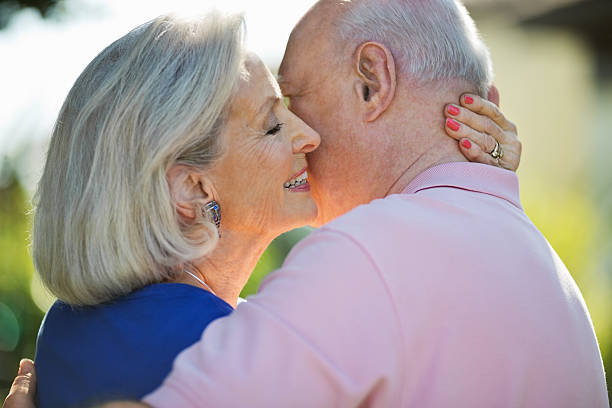 istock Senior Woman Embracing Husband In Park 164465124