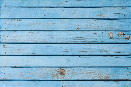 Old weathered blue wooden board background.