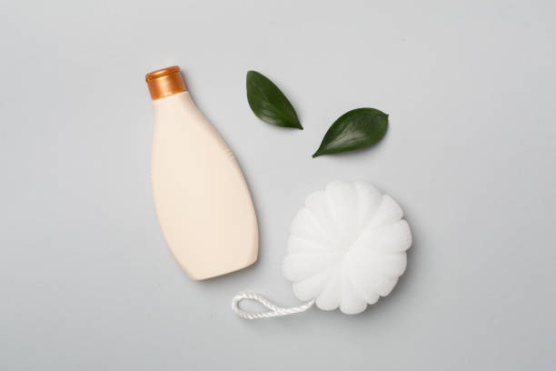 istock Shower gel with washcloth on color background, top view 1644652909