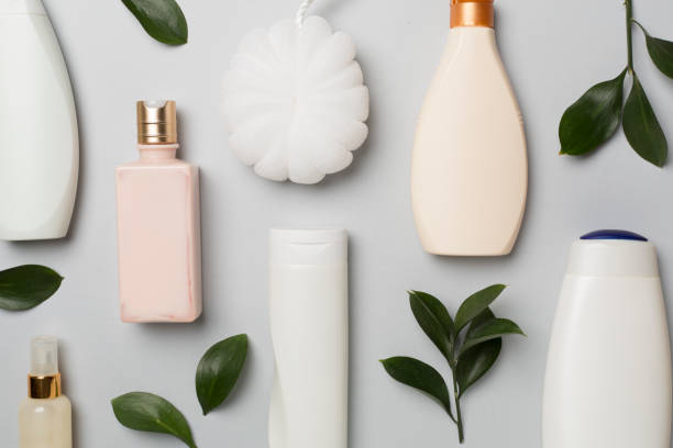 istock Different cosmetic bottles and washcloth on color background, top view 1644652912