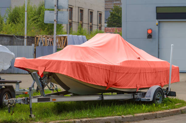 istock A small boat on a trailer, covered with a cover 1644653483
