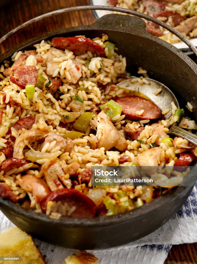 Jambalaya Cajun Style Chicken and Sausage Jambalaya in a Cast Iron Pot with Hot sauce and corn bread- Photographed on Hasselblad H3D2-39mb Camera Andouille Stock Photo