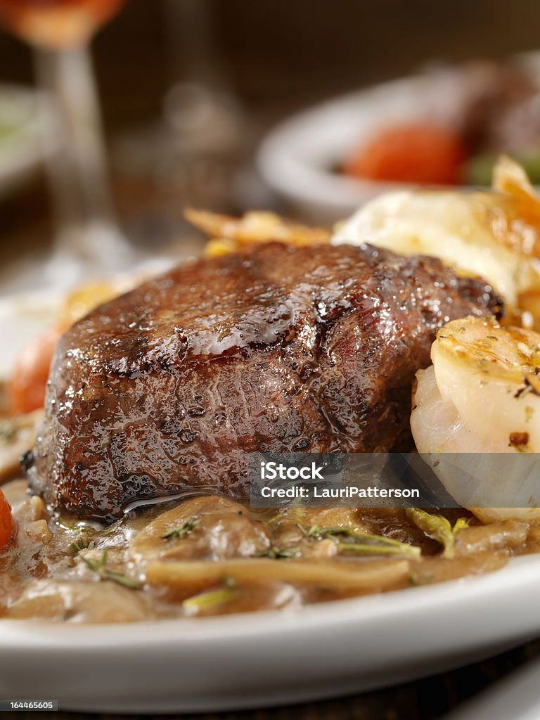 Beef Tenderloin Steak Beef Tenderloin Steak with Jumbo Shrimp, Pepper Mushroom Sauce, and roasted Tomatoes -Photographed on Hasselblad H3D2-39mb Camera Beef Stock Photo