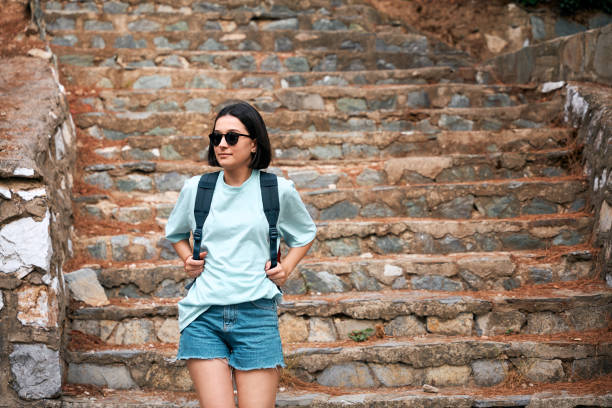 young woman goes down stairs down her way to university