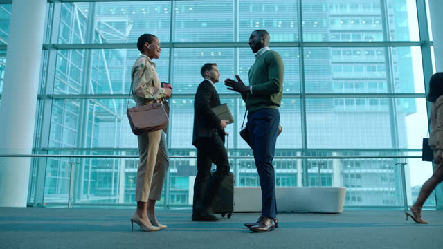 Airport, handshake and business people greeting for meeting and talking as networking together for partnership. Hello, welcome and employees shaking hands at a corporate or international travel trip
