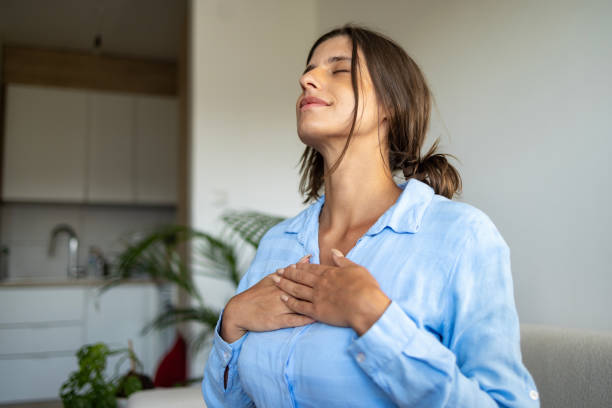 istock Beautiful woman doing breathing exercise at home 1644662753