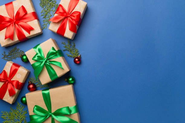 istock Gift boxes with decor on color background, top view 1644663056