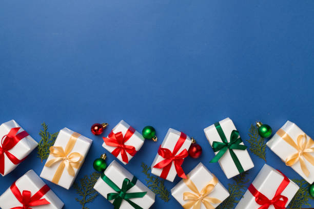 istock Gift boxes with decor on color background, top view 1644663067