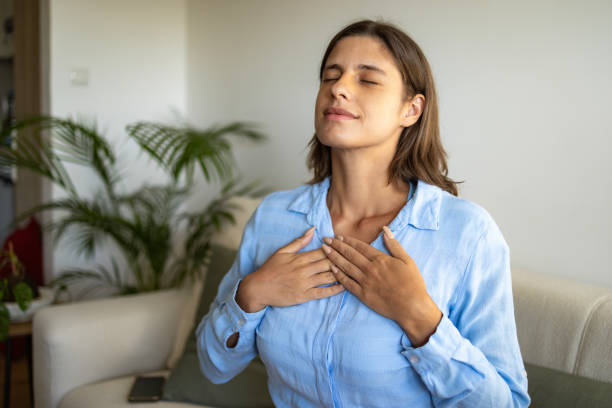 istock Content woman sitting on sofa with closed eyes breathing 1644663104