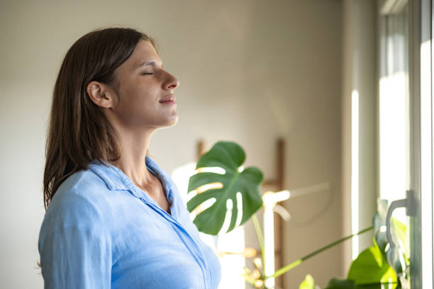 istock Happy woman open window drapes close eyes in delight 1644663105