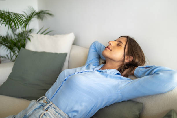 istock Beautiful woman doing breathing exercise at home 1644663106
