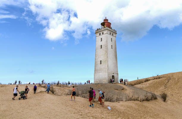 Rubjerg Knude Lighthouse on the coast of the North Sea in the Jutland in northern Denmark. Natural landscape with sand dunes.