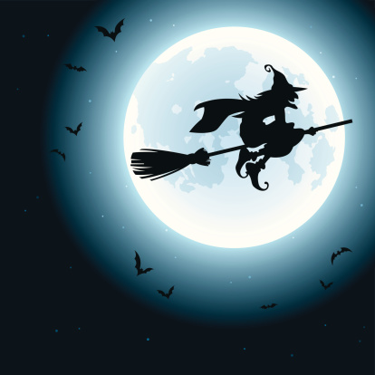 A Halloween image of a witch on a broom