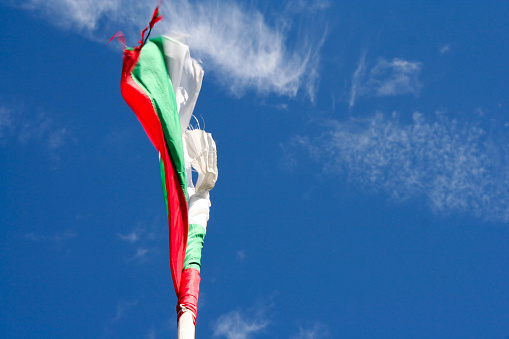 Bulgarian flag blown by the wind in the blue sky.
