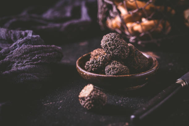 istock Expensive black truffles gourmet mushrooms  on kitchen table 1644708004