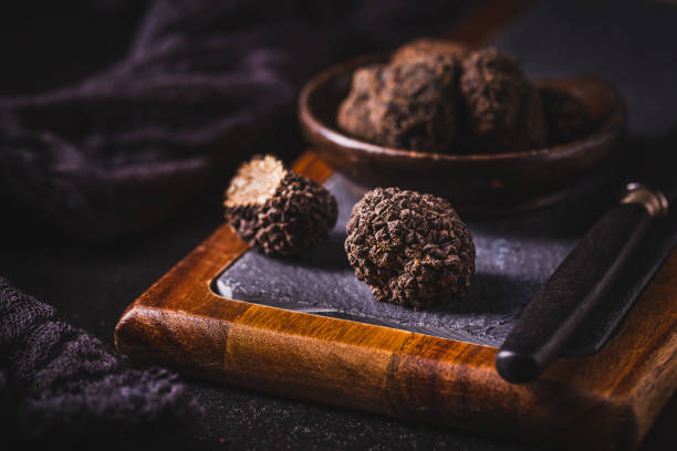 istock Expensive black truffles gourmet mushrooms  on kitchen table 1644708011