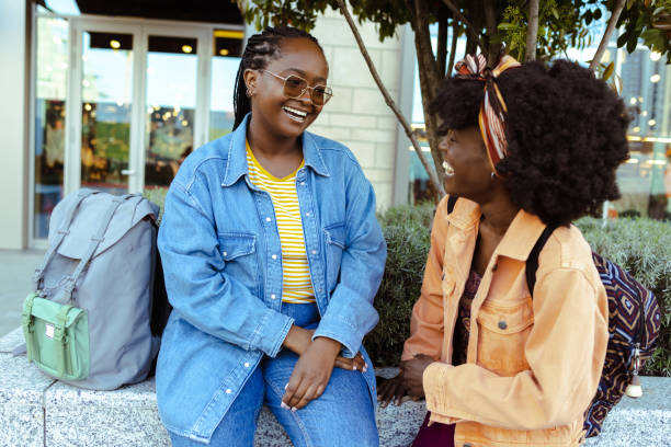 istock Two African American friends talking and laughing 1644714999