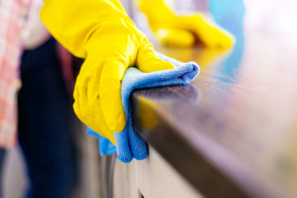 istock Woman hand cleaning the counter in the kitchen with a blue microfiber cloth 1644723630
