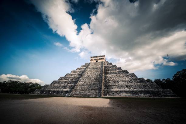 istock Ancient structure situated within a lush green field, surrounded by white clouds in the sky 1644725645