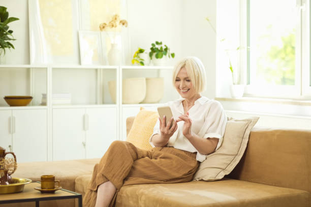 istock Happy mature woman using smart phone 1644726315