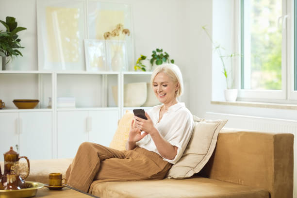 istock Happy mature woman using smart phone 1644726832