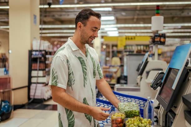 istock Handsome man paying contactless with his mobile phone 1644732758