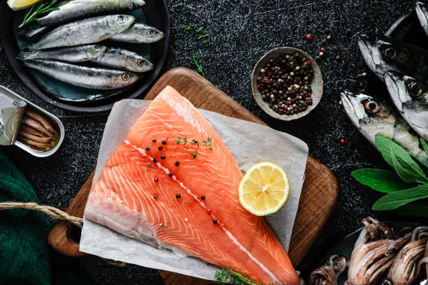 istock Raw salmon steak with herbs and spices on table 1644734407