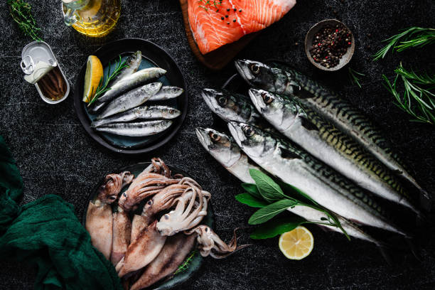 istock Fresh fish and seafood on black table 1644736160