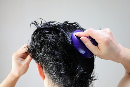 Close-up of a person using a hairbrush