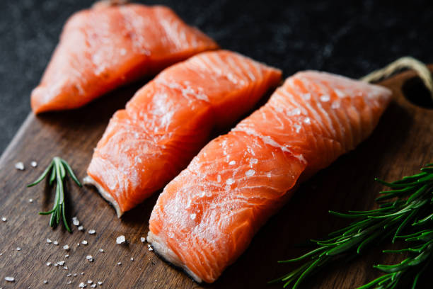 istock Raw salmon fillets with spices on kitchen table 1644748934