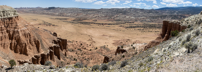 Beautiful red and orange rock formations make au Capitol Reef and Cathedral Valley in Utah. They give this desert land an otherworldly look. panorama photo