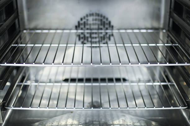 A close-up of the interior of a clean oven Inside of a modern empty oven. Close-up with wide angle lens, shiny silver inside. oven stock pictures, royalty-free photos & images