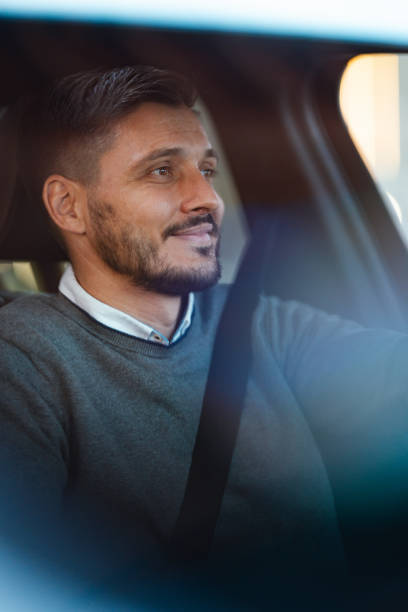 istock A Happy Handsome Businessman Looking Away While Sitting In A Car 1644775198