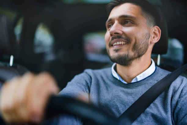 istock A Happy Handsome Businessman Looking Away While Driving His Car 1644775764